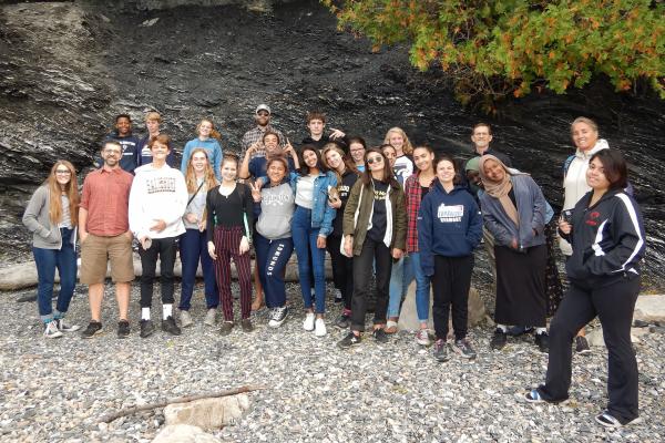 Burlington City and Lake students and staff on rocky waterfront beach